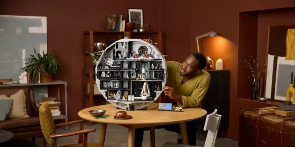 A man sitting at a table with a toy