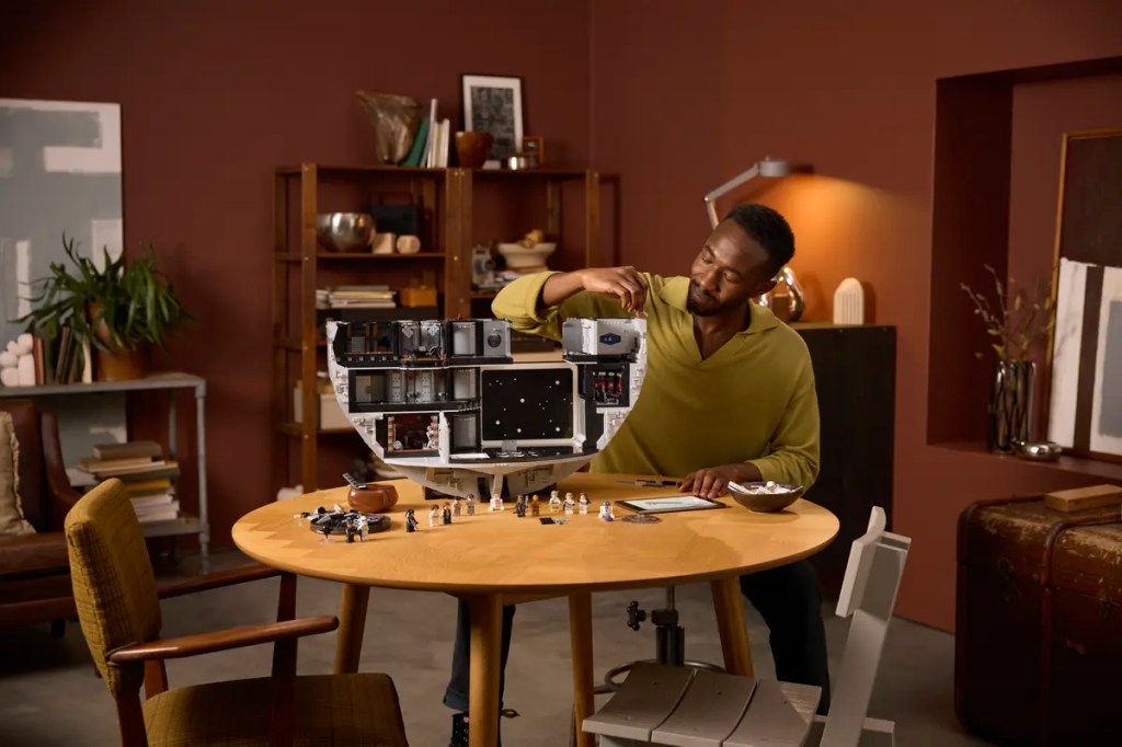 A man working on a model of LEGO Star Wars Death Star