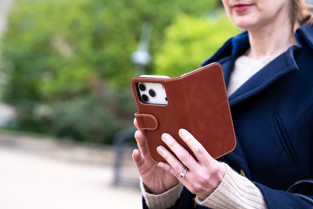 A woman holding a phone case