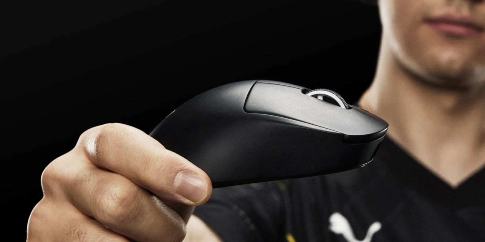 Image showing a person holding Logitech's G Pro X Superlight 2 DEX gaming mouse in black.