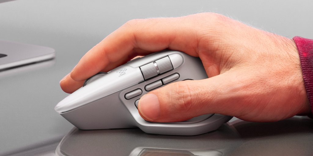 A hand holding a computer mouse