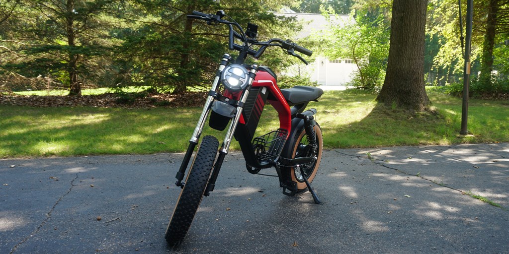 A red and black motorcycle parked on a driveway