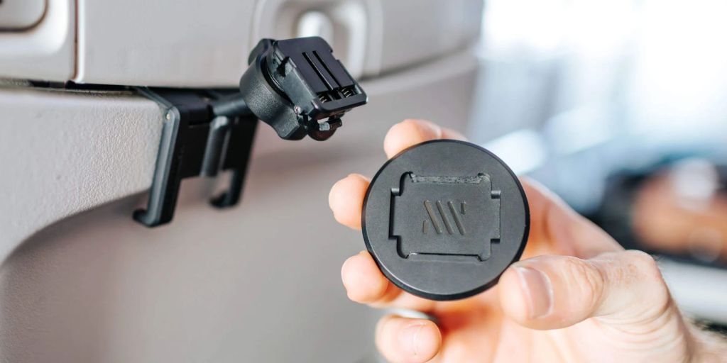 A hand holding a round object.