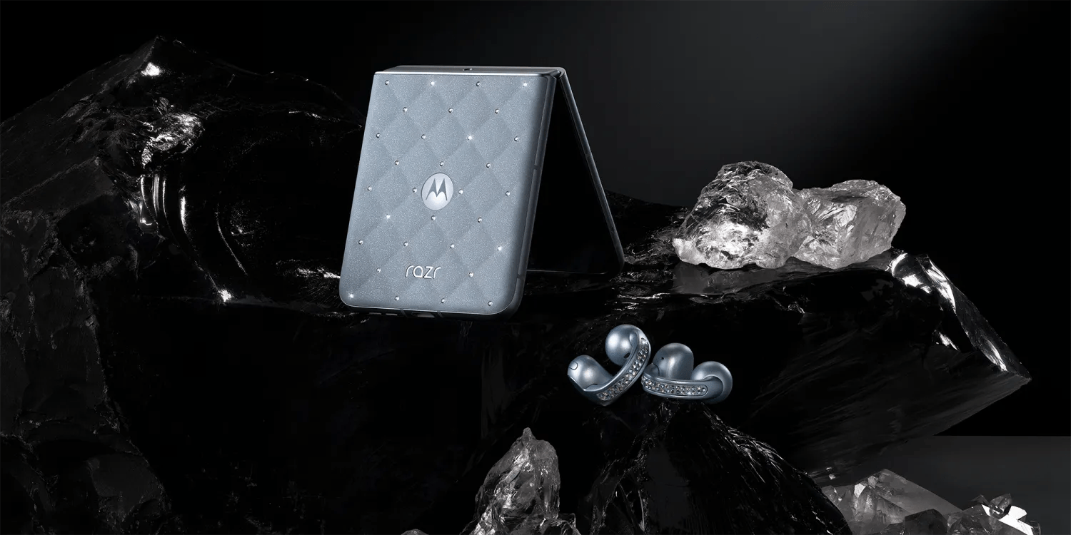 A silver rectangular device with diamonds on it next to a pair of earphones