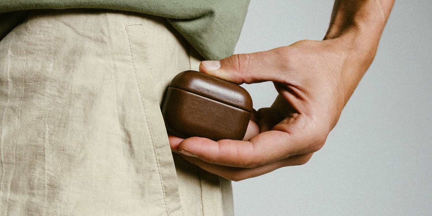 A person holding a small brown box