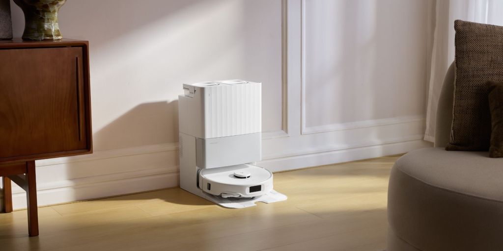 A robot vacuum cleaner on a wood floor