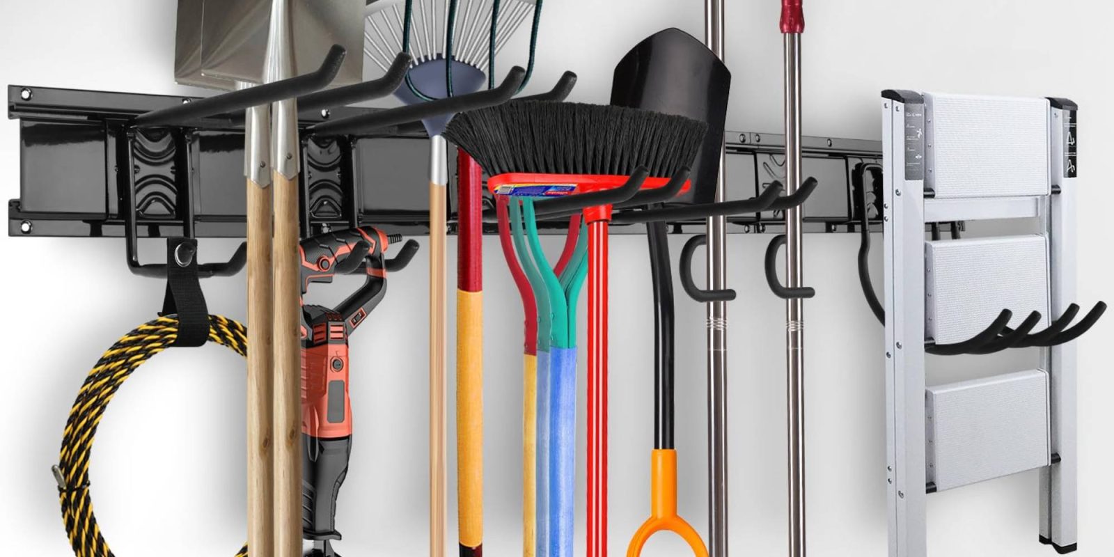 A rack with brooms and rakes