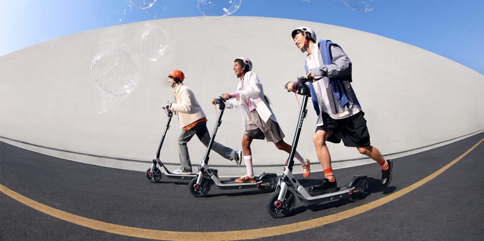 A group of people riding scooters