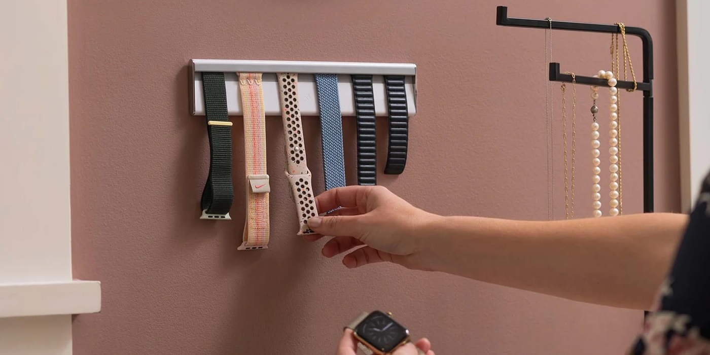 A person's hand holding a watch