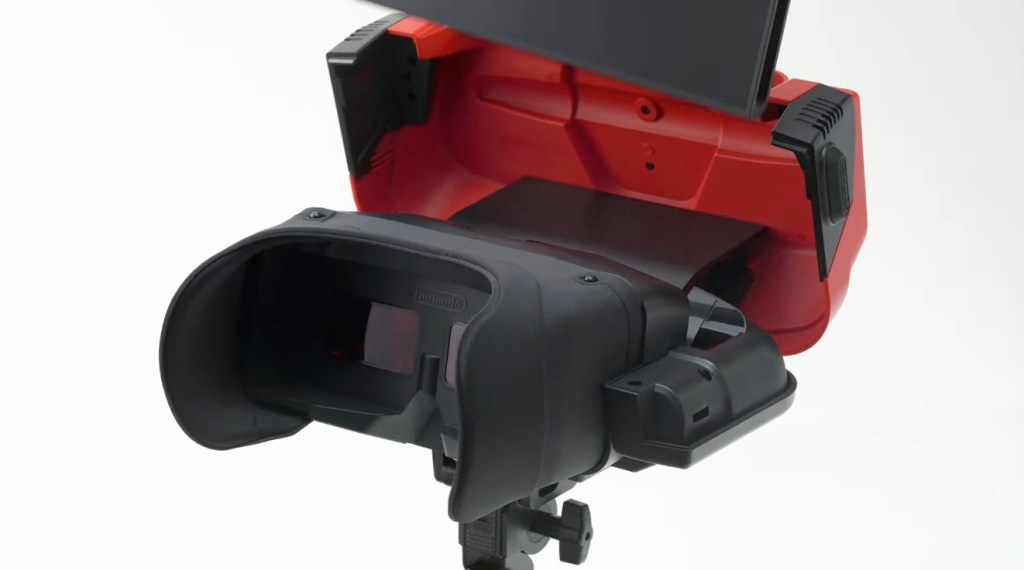 A black and red device with a black lens