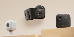 A group of black cameras on a wooden surface