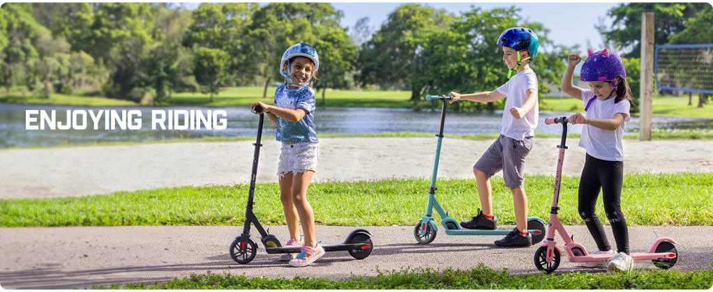A boy and girl riding scooters