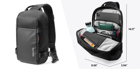 A black backpack with a cell phone and a bottle inside