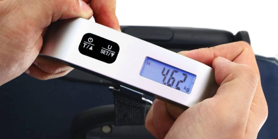 A person holding a weight scale