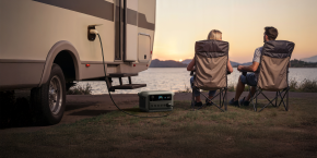 A couple of people sitting in chairs next to a power outlet