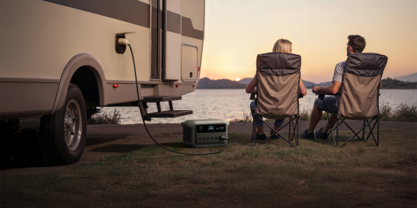 A couple of people sitting in chairs next to a power outlet