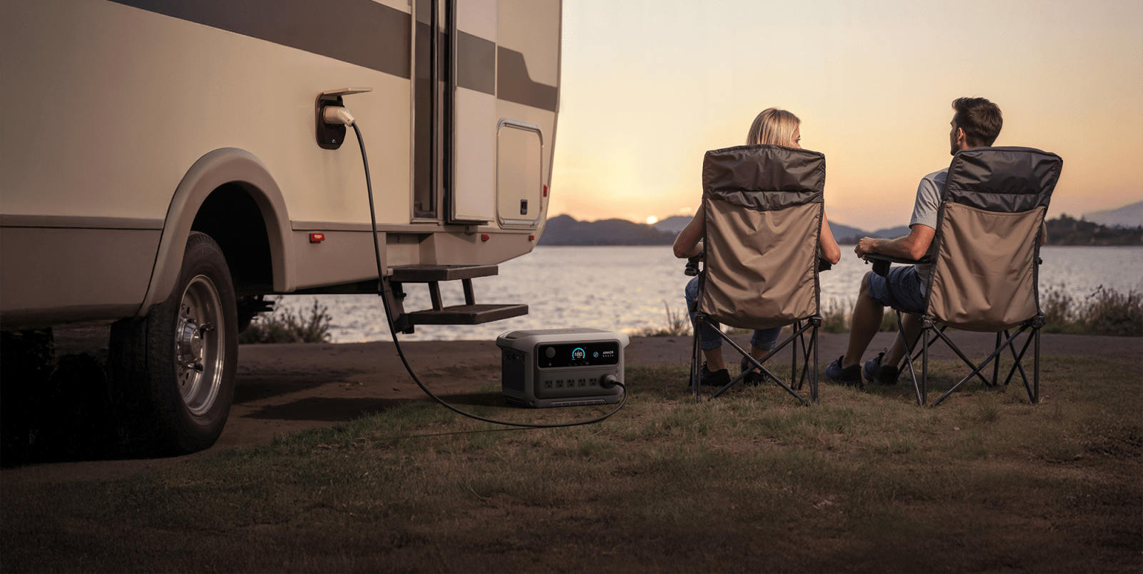 A couple of people sitting in chairs next to a power outlet
