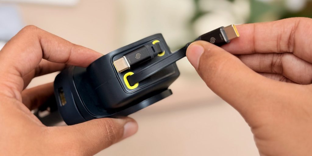 A person holding a cable of a car charger.