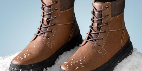 A pair of brown boots with snow on them