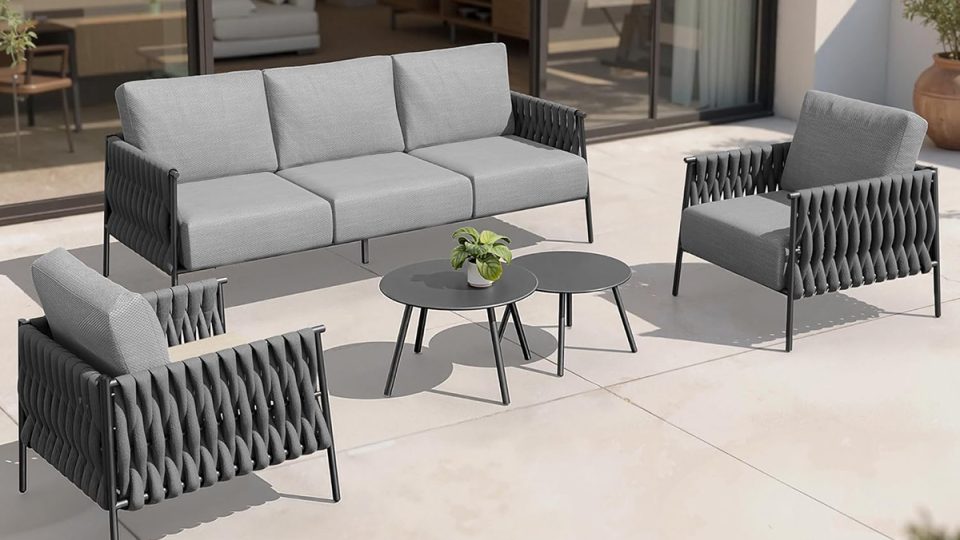 A sofa and chairs outside