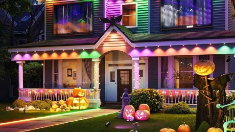 A house with colorful lights and pumpkins