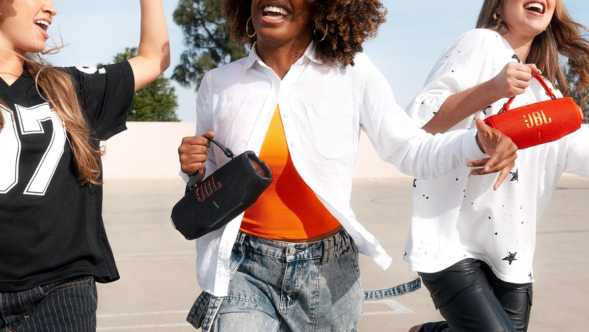 A woman with curly hair and a white shirt and orange shirt