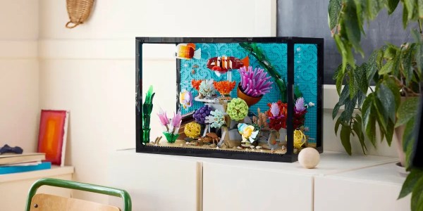 A fish tank with colorful objects on a white cabinet