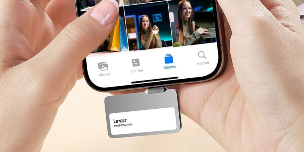 A hand holding a phone with a card