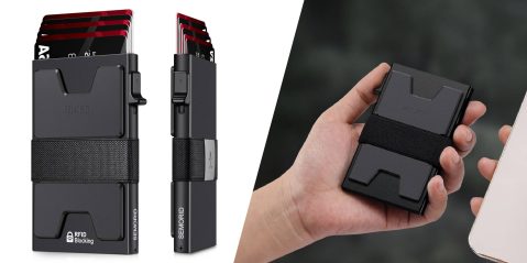 A hand holding a black card holder