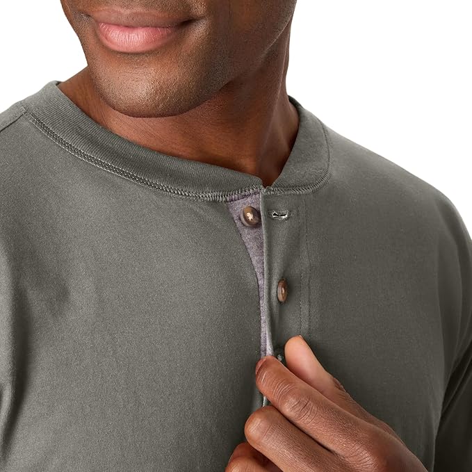 A man buttoning a shirt