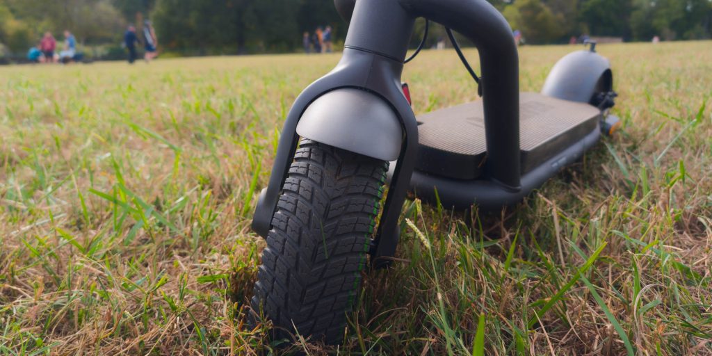 A black scooter in grass