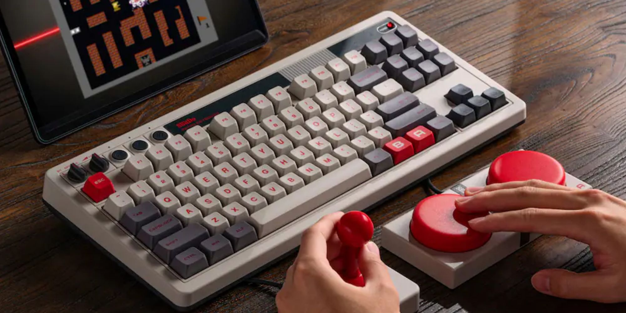 A keyboard and a hand holding a red stamp