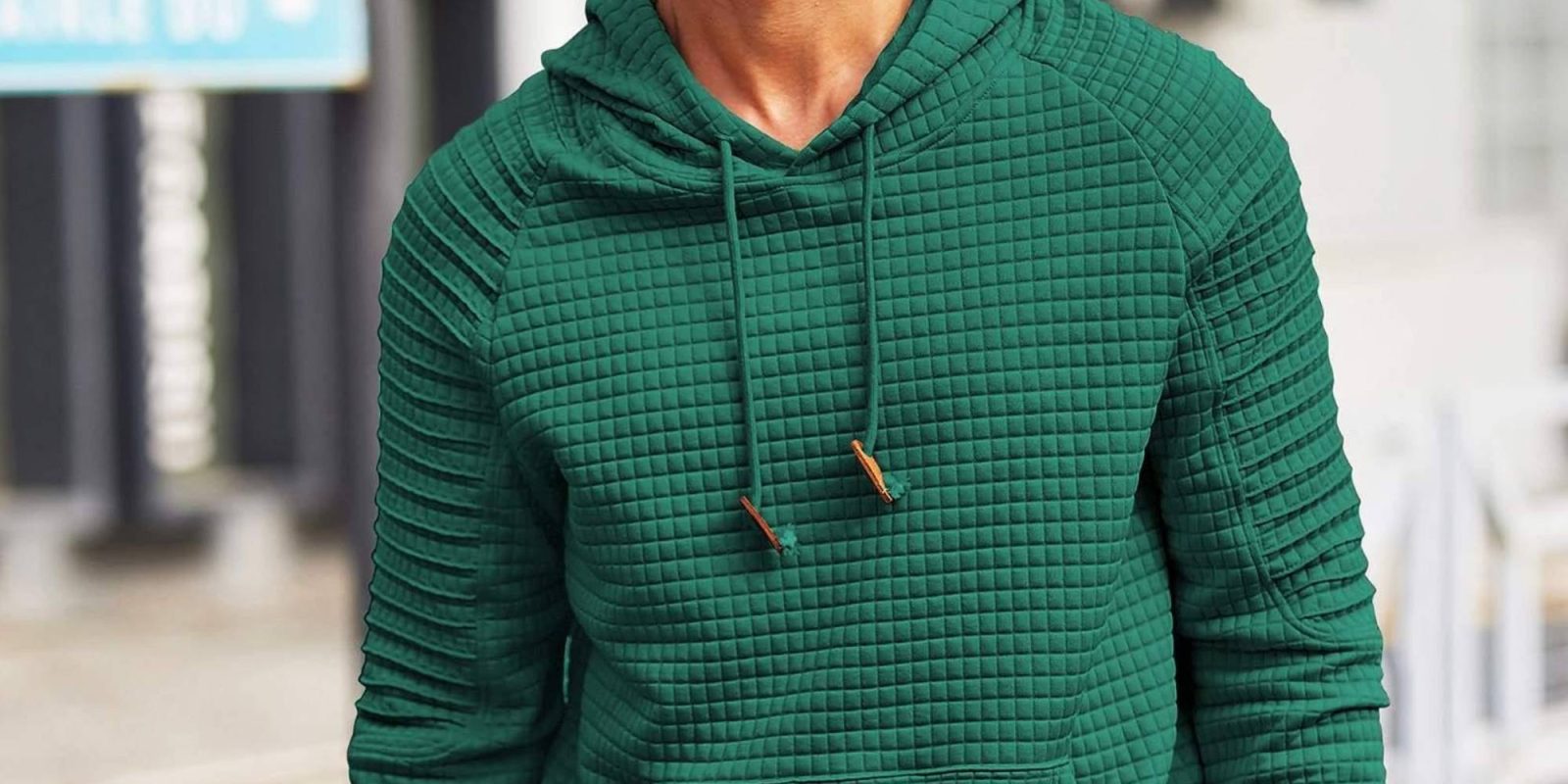 A person wearing a green hoodie