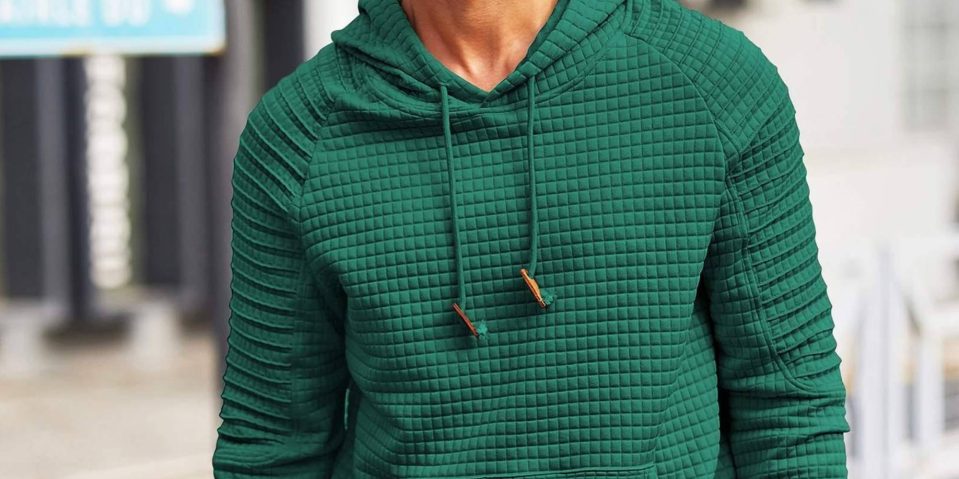 A person wearing a green hoodie