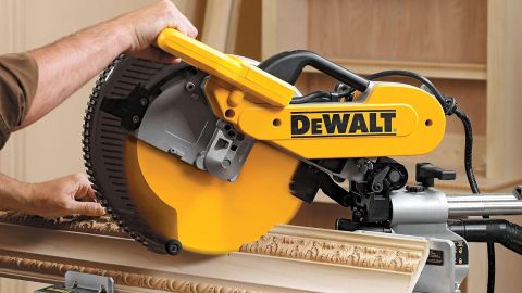 A hand holding a circular saw