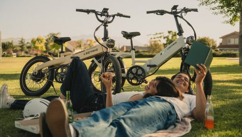 A man and woman lying on a blanket next to bicycles