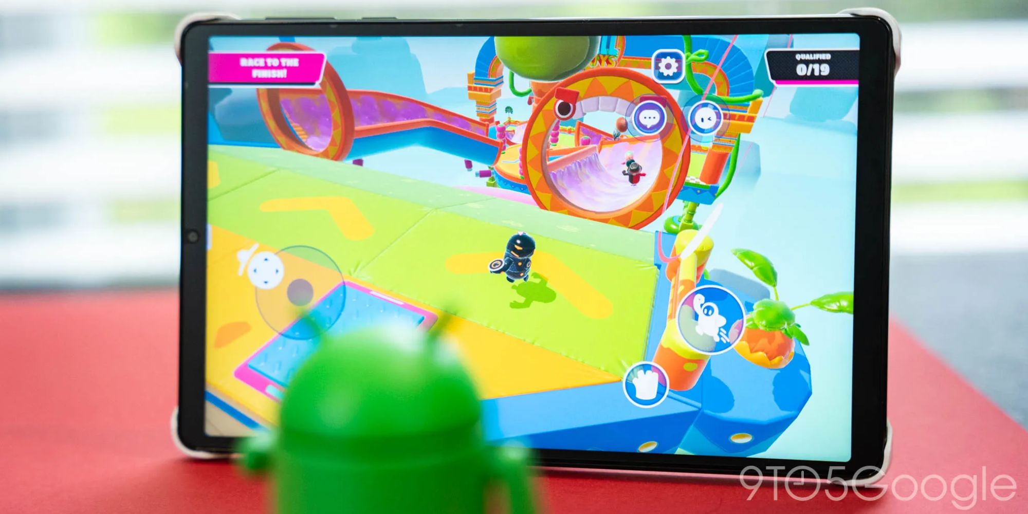 A green robot on a tablet