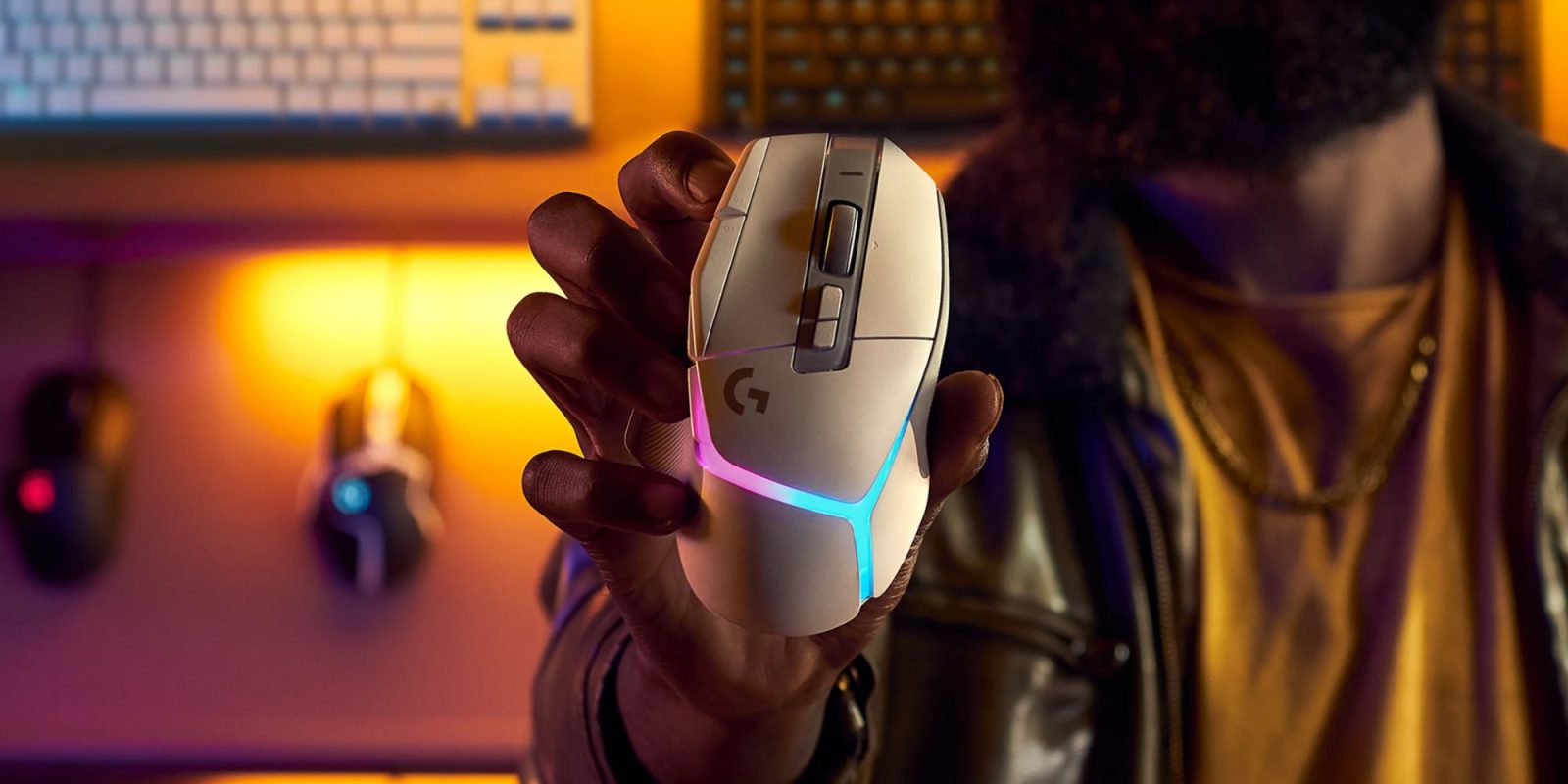 Image showing a person holding Logitech's G502X LIGHTSPEED wireless gaming mouse in white.