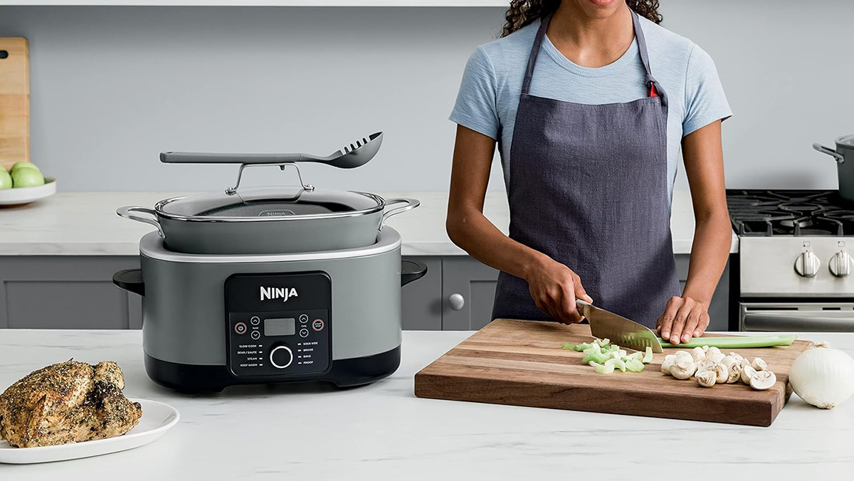 A woman cutting vegetables on a cutting board