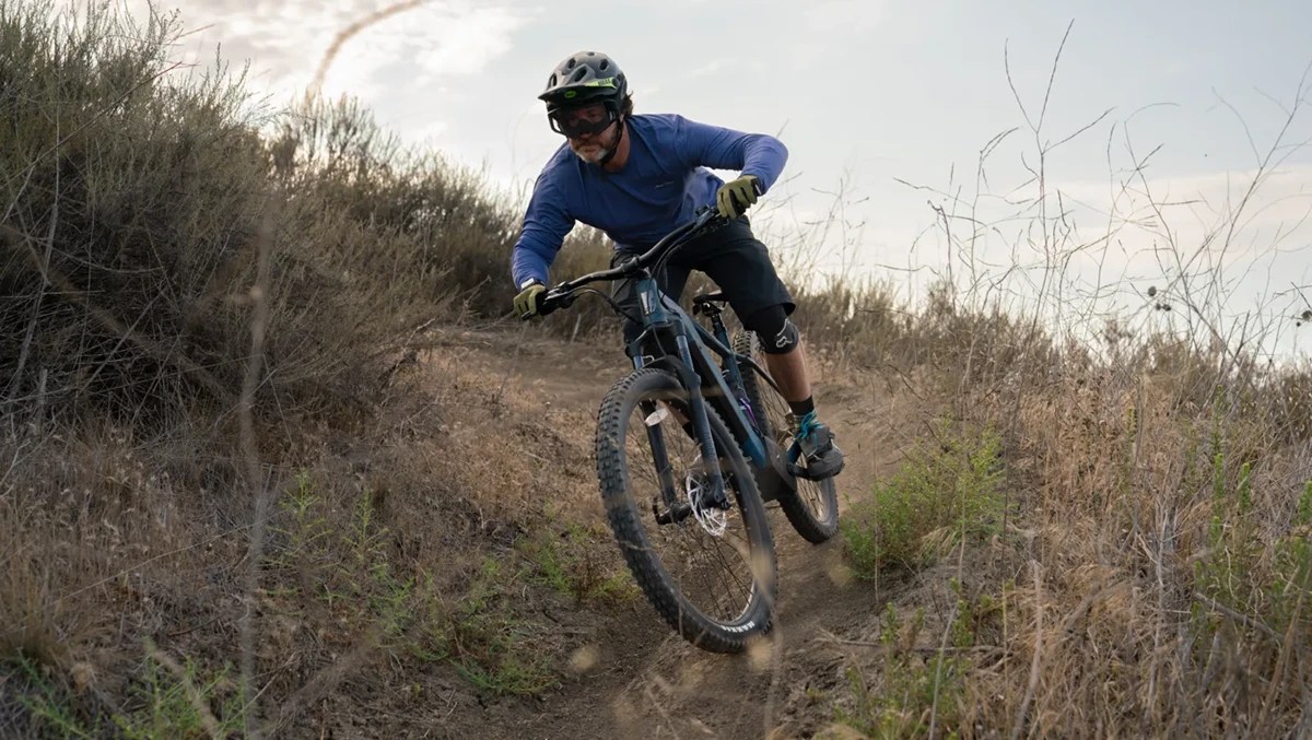 A man riding a bike on a dirt trail