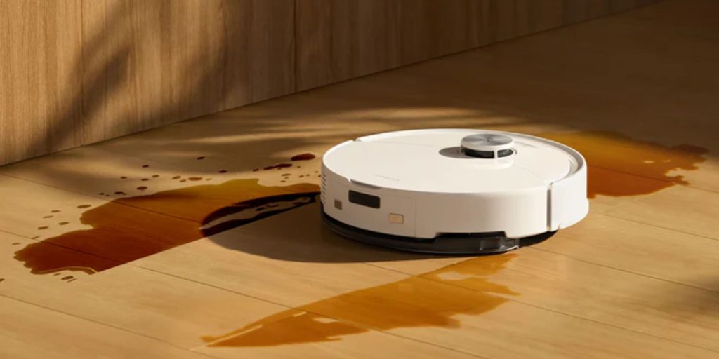 A robot vacuum cleaner on a wooden floor