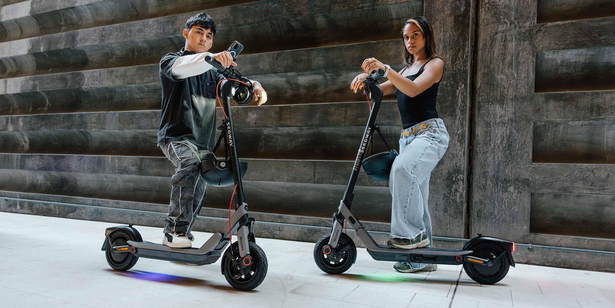 A man and woman on scooters