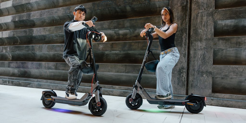 A man and woman on scooters