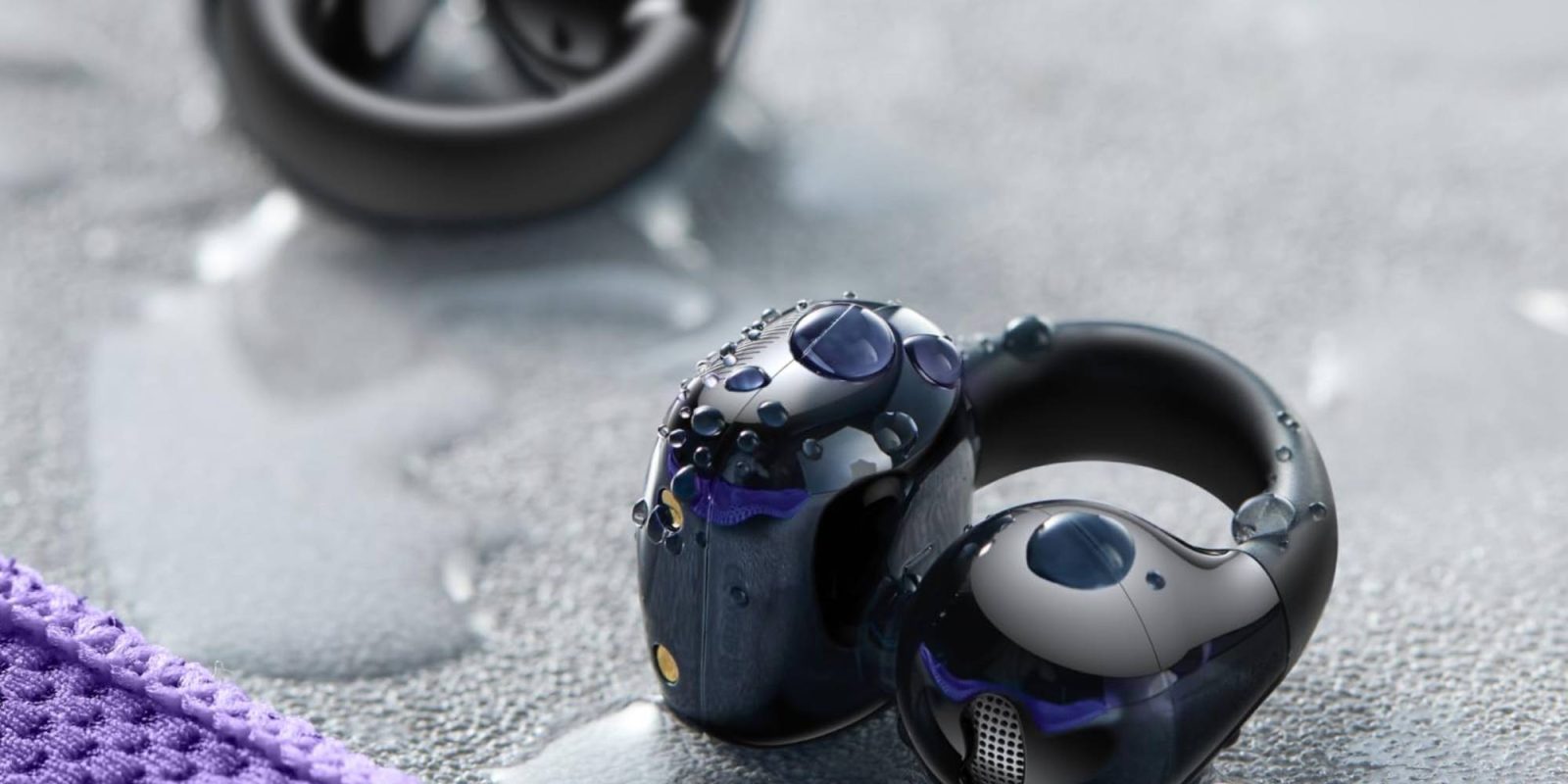 A close up of a black earbuds