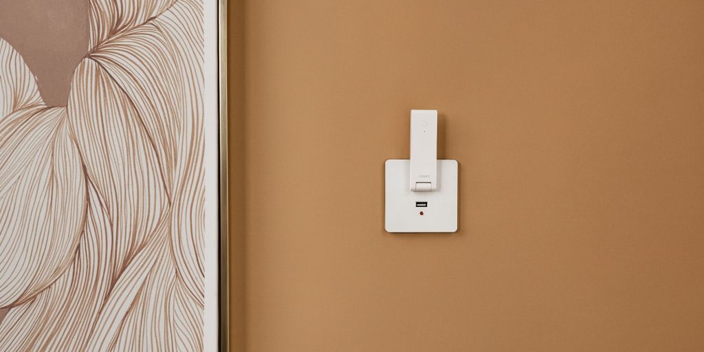 A white rectangular object on a brown wall