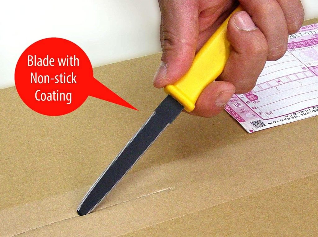 A hand holding a file with a yellow handle