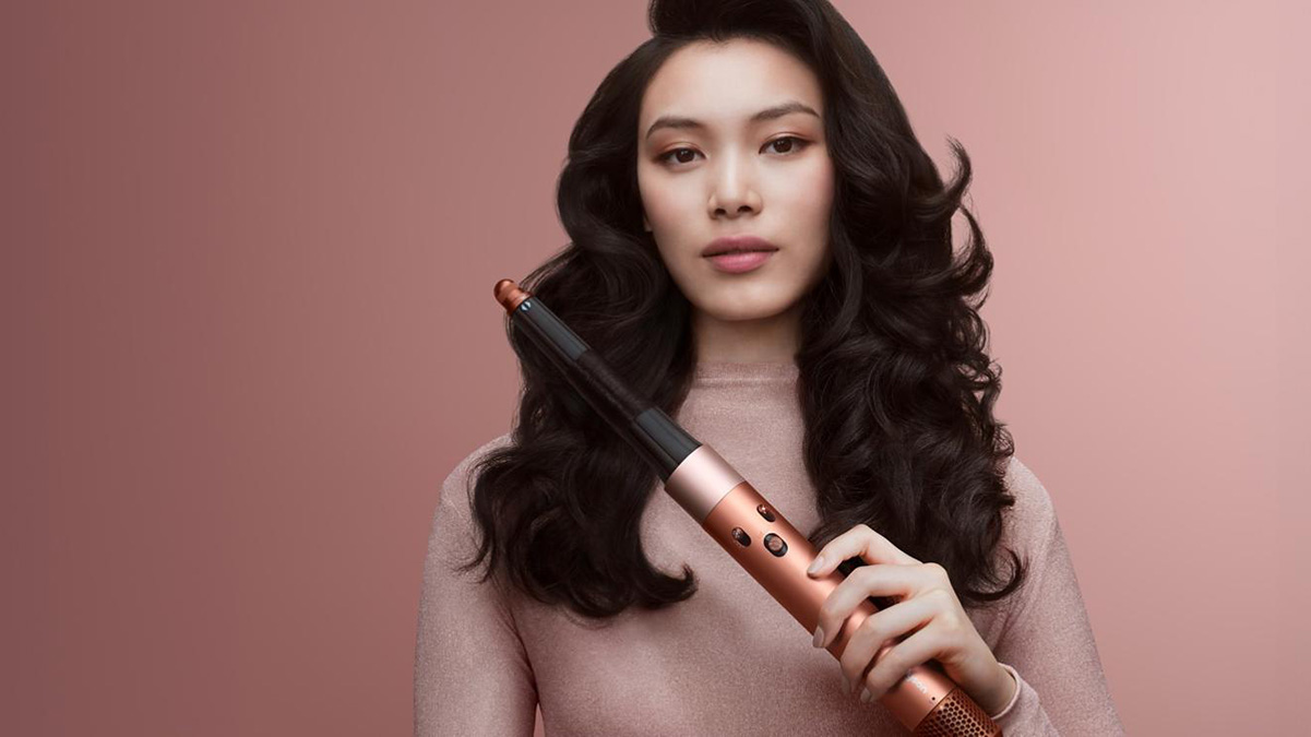 A woman holding a curling iron