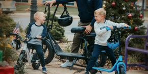 A group of kids with helmets and scooters
