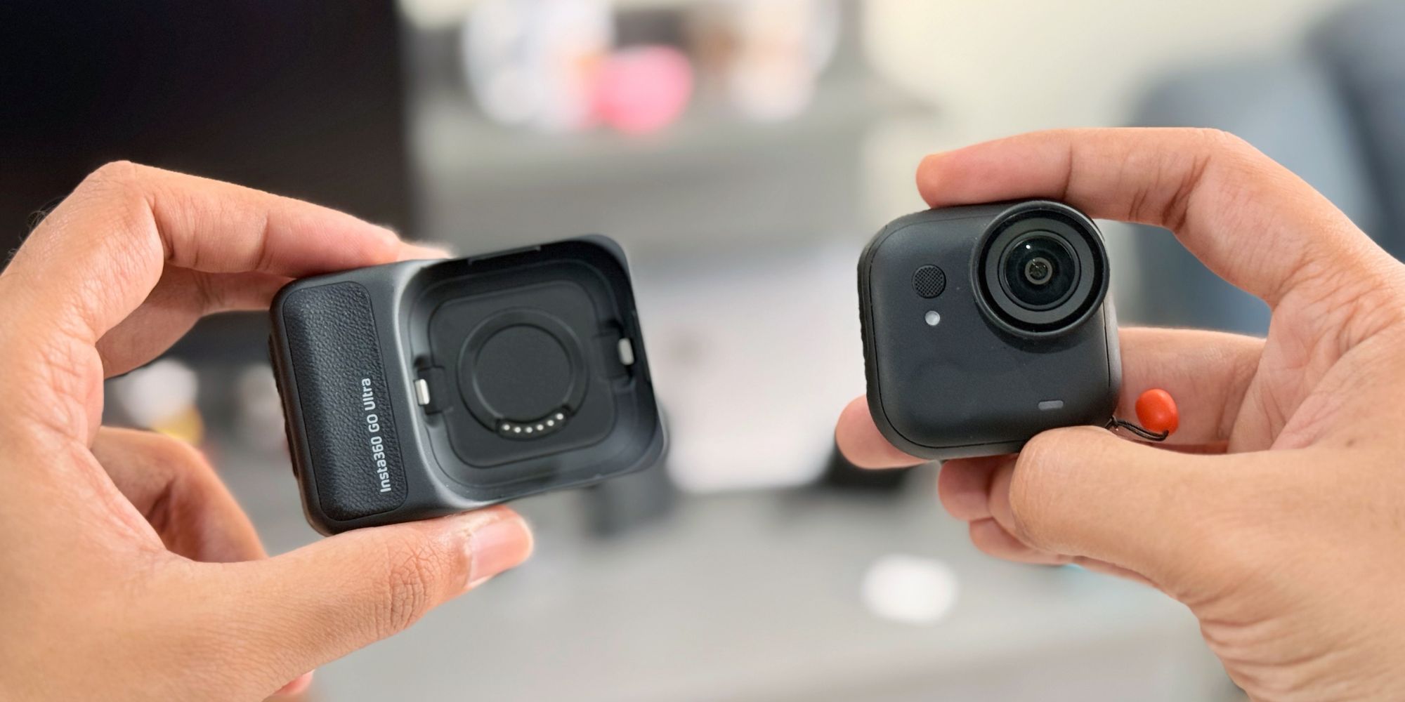 A pair of hands holding cameras