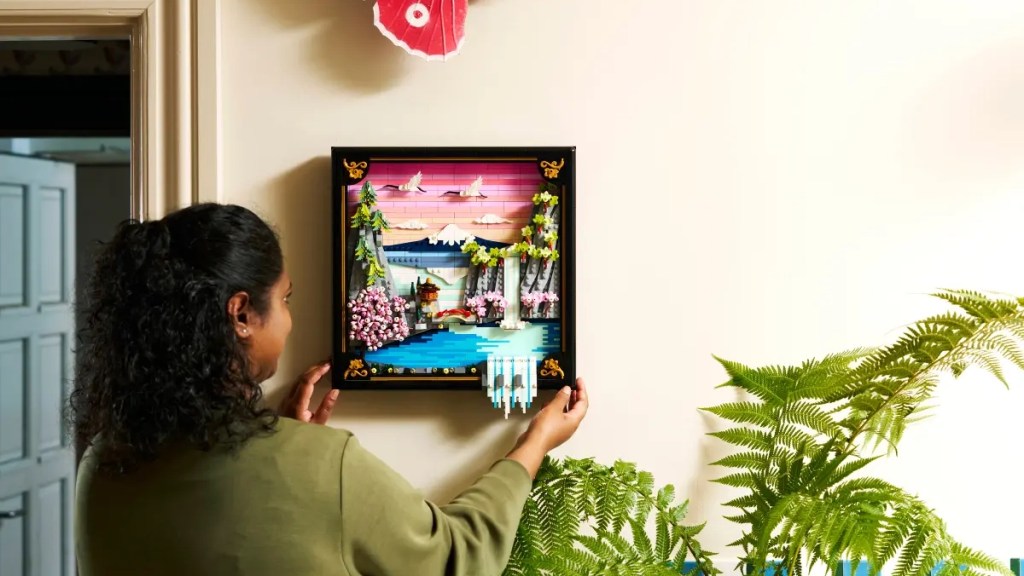 A woman a picture on a wall